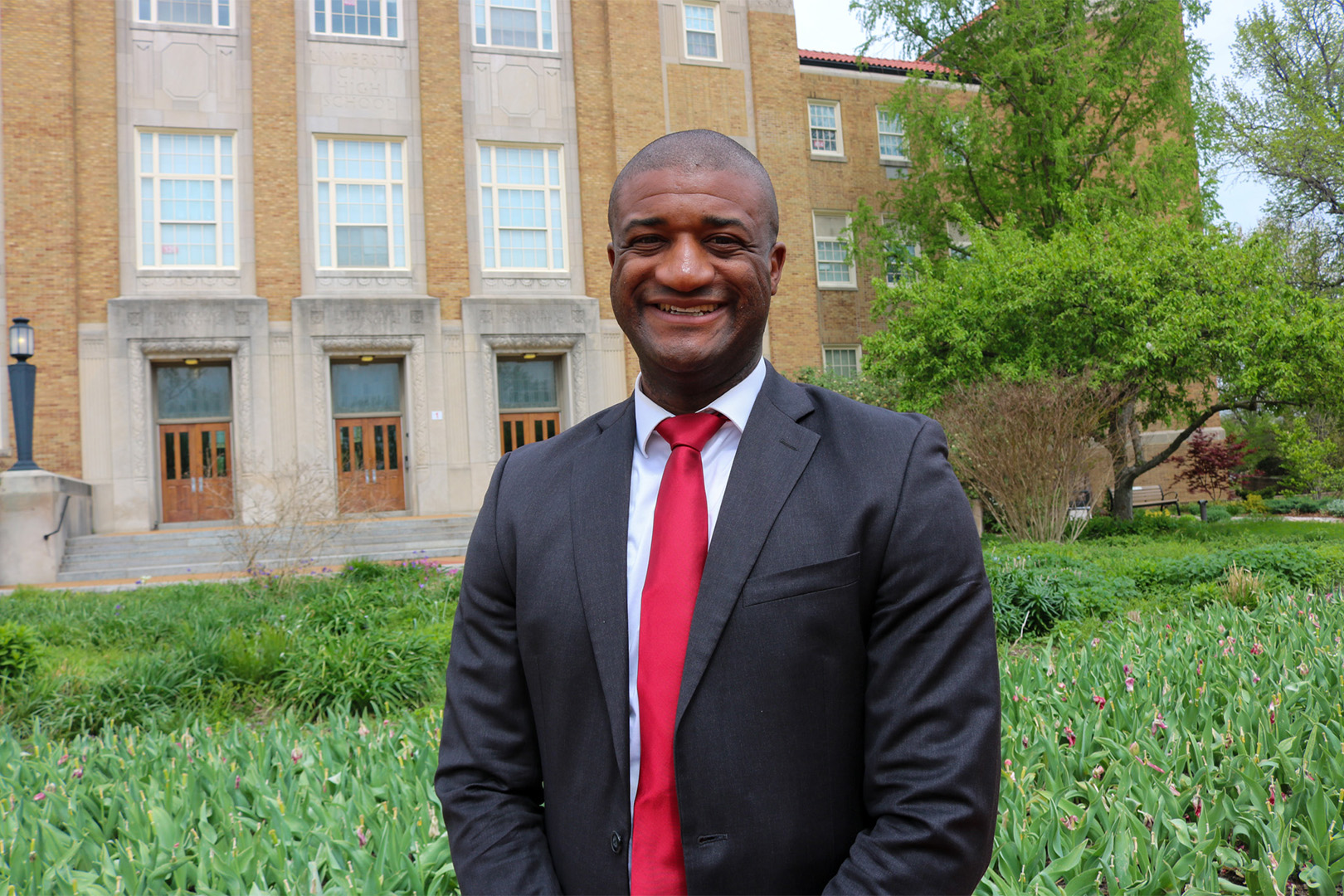 Vernon Norman wearing a suit in front of University City Senior High School